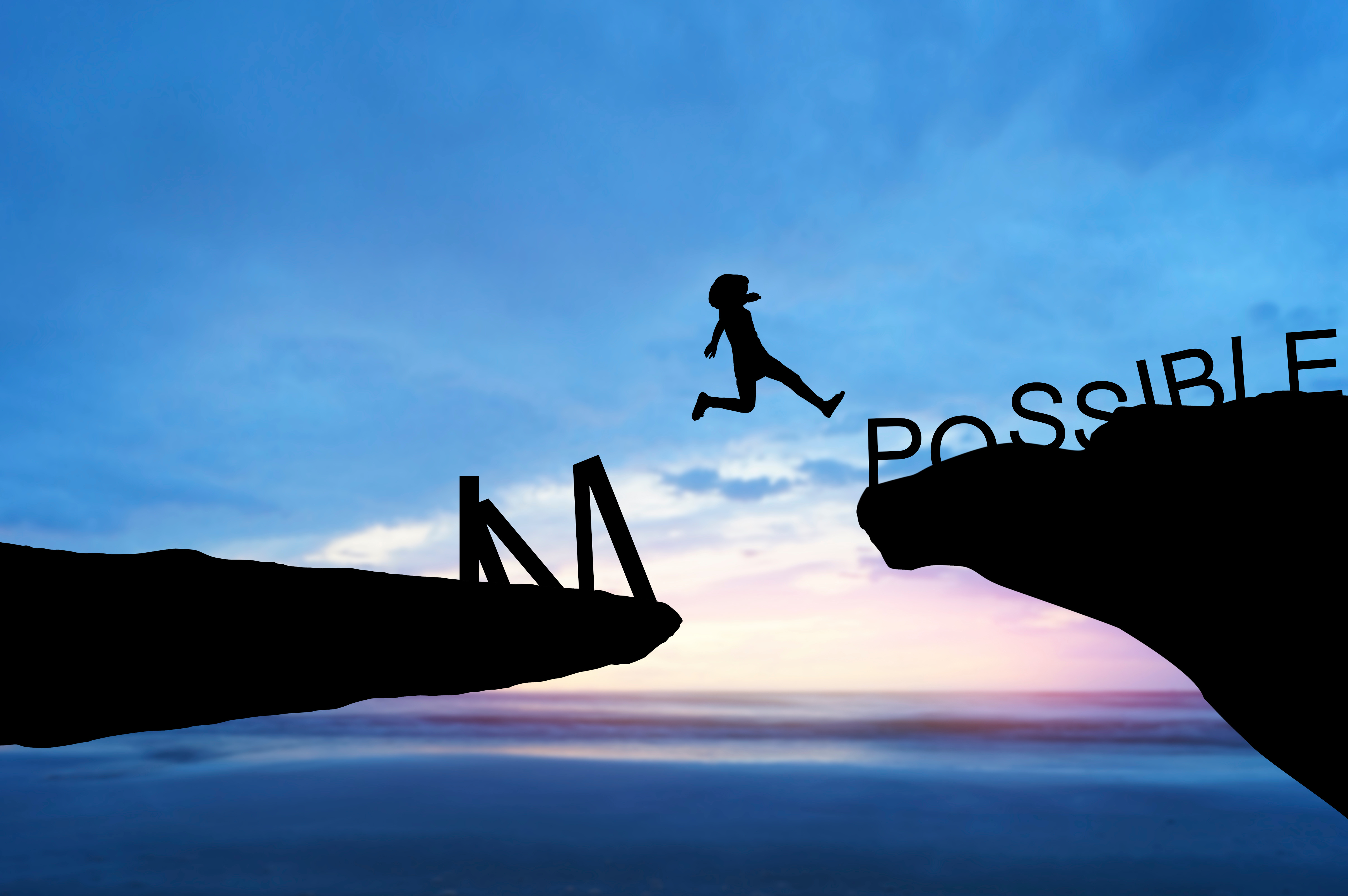 the silouhette of a person pole vaulting from left to right over a canyon with the letters "IM" on the left side and "POSSIBLE" on the right side